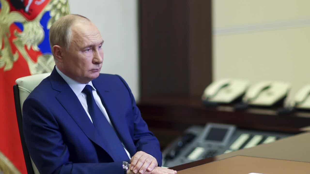 Russian President Vladimir Putin listens to the acting leader of Kursk