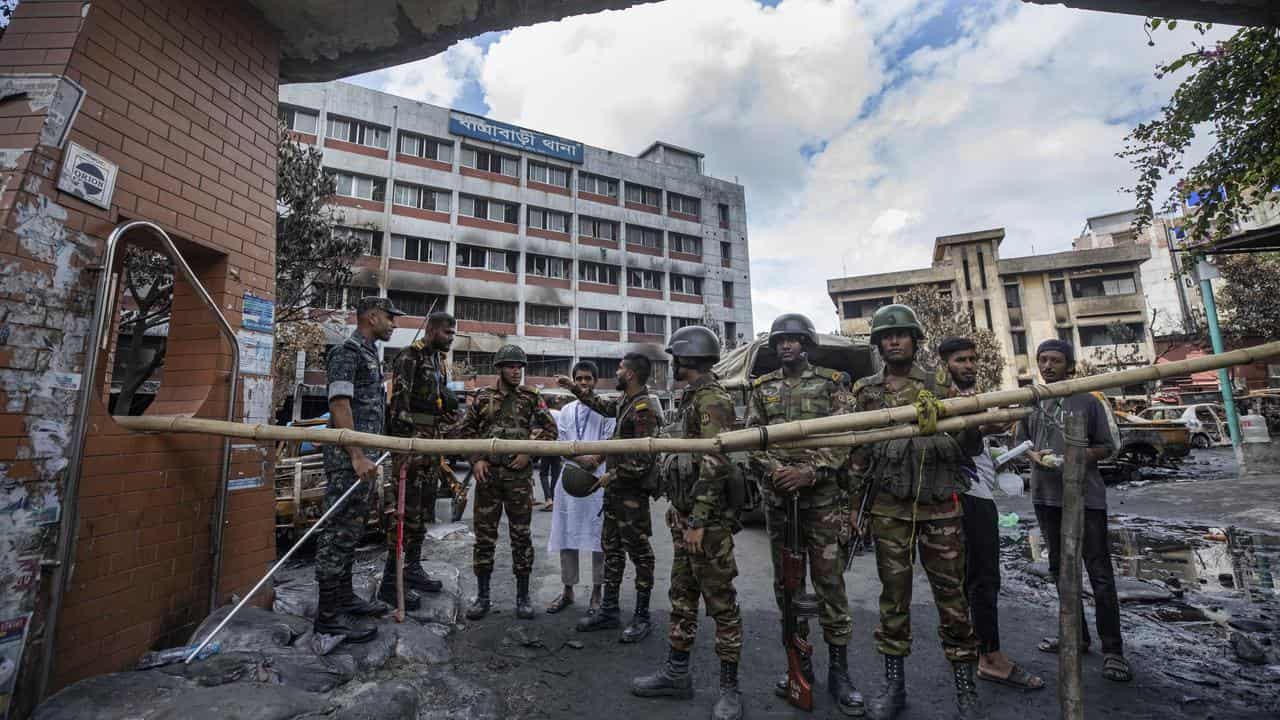 Army personnel stand guard in front of Jatrabari Police Station