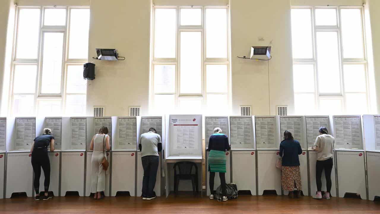 Voters cast their vote at a polling station