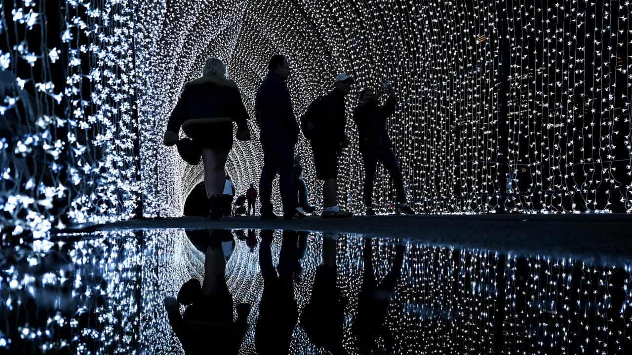 People walk through the Cathedral of Light installation