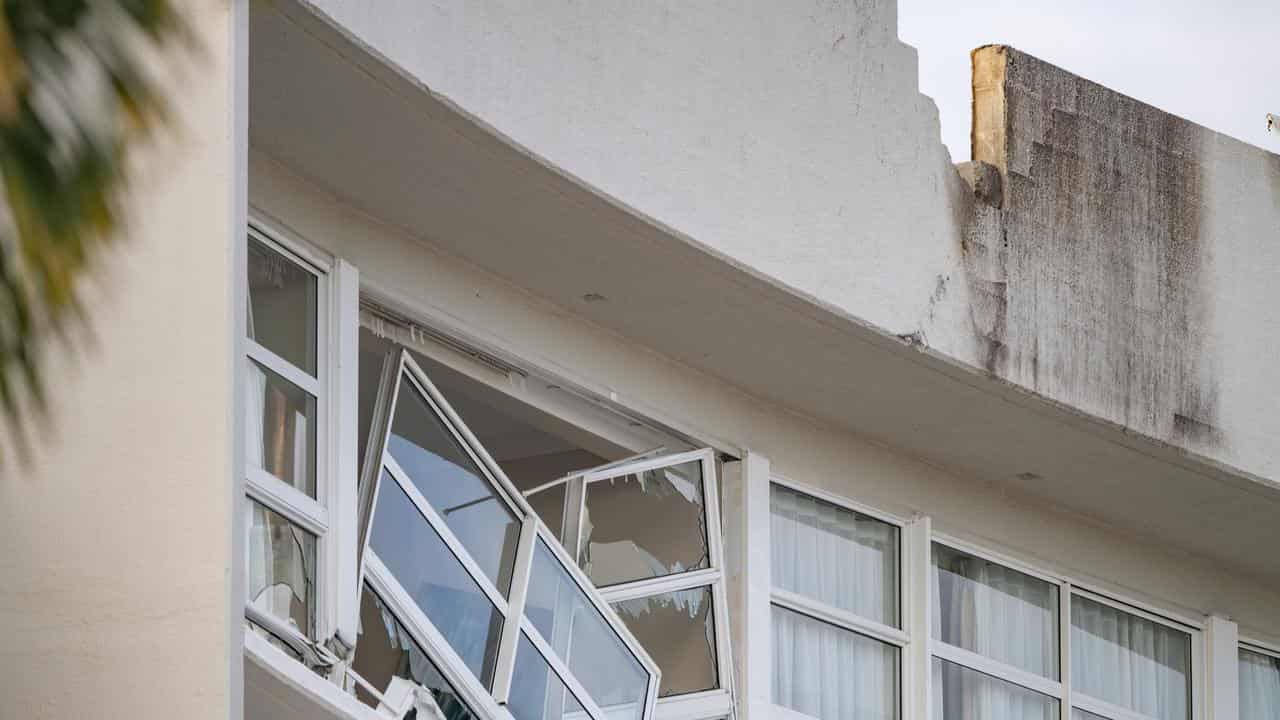 Broken window and damaged rooftop after a helicopter crash in Cairns