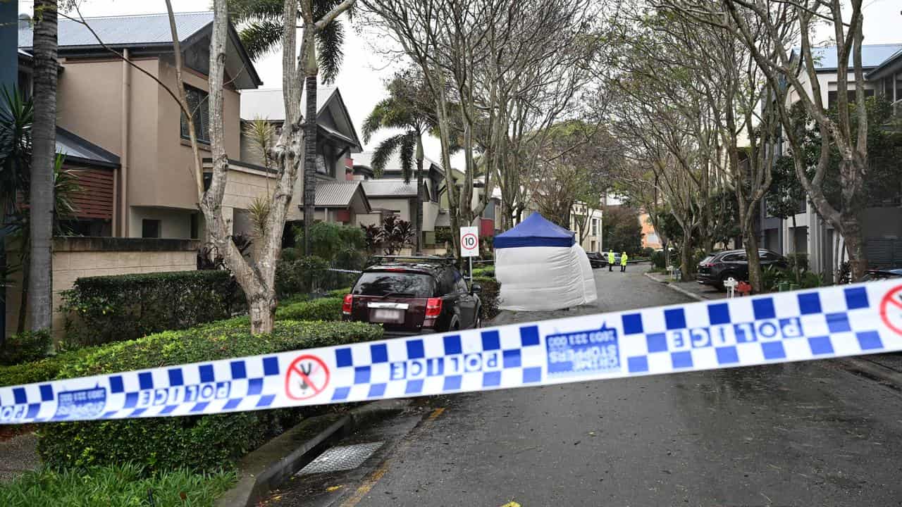 Police are seen at a crime scene in Carrara