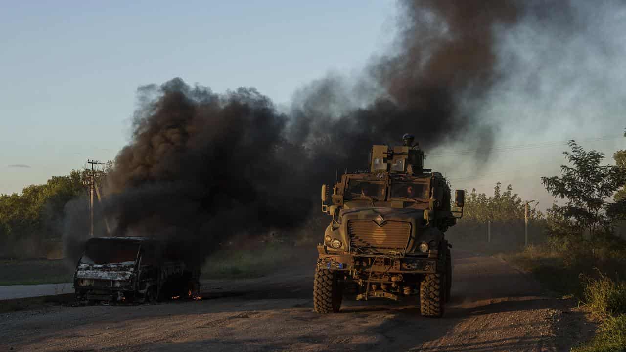 A Ukrainian armoured vehicle travels near the Russian border