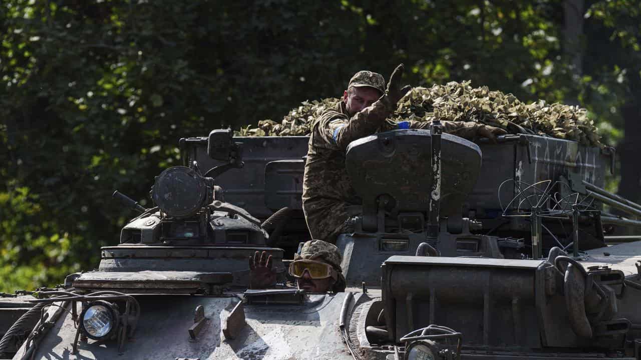 Ukrainian servicemen on an armoured vehicle at the Russian border