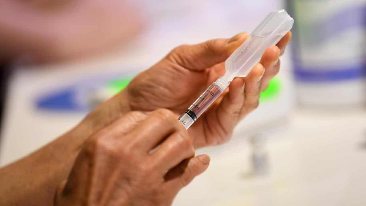 A healthcare worker prepares a vaccination (file image)