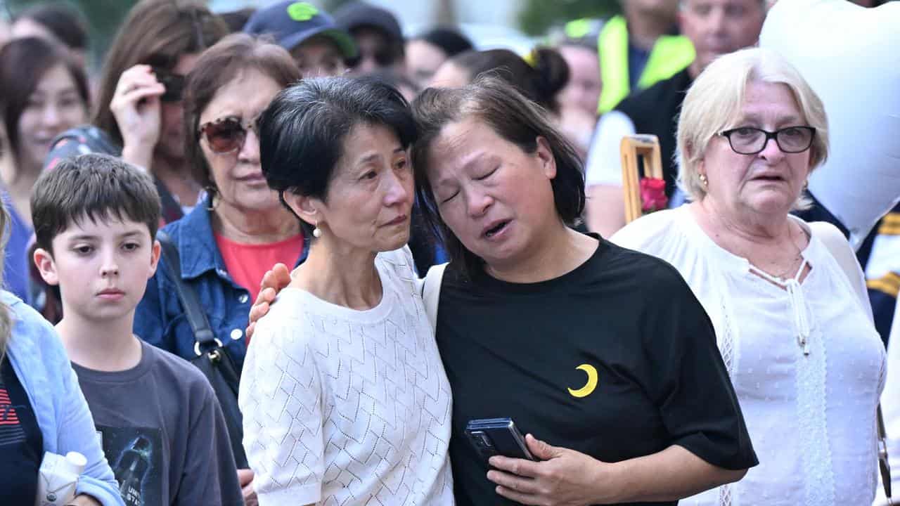 Mourners hugged and comforted each other