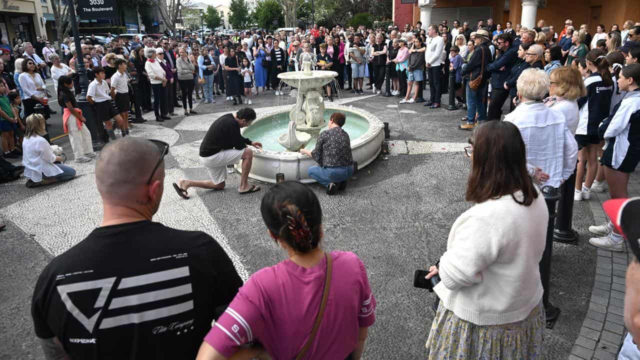 People lit candles and placed them around in a fountain