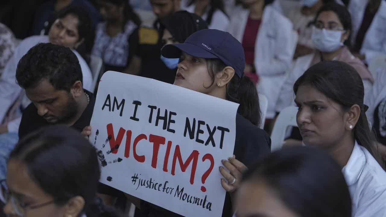 A doctor holds a placard during a protest in Hyderabad, India