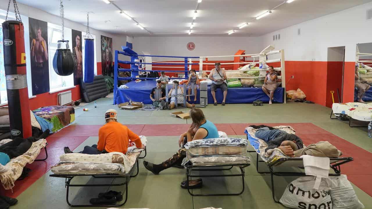 Civilians camped out in a gym