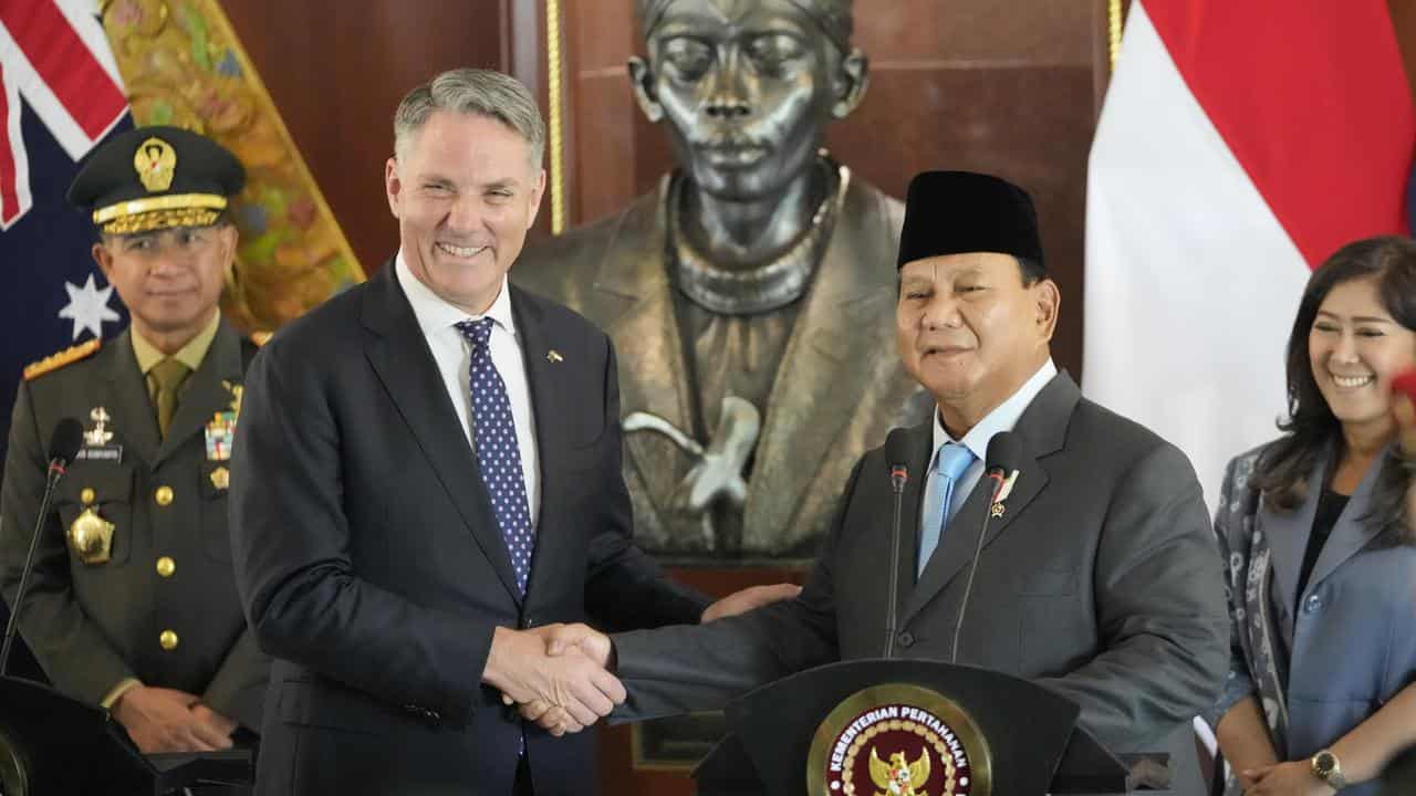 Richard Marles and Prabowo Subianto shake hands.