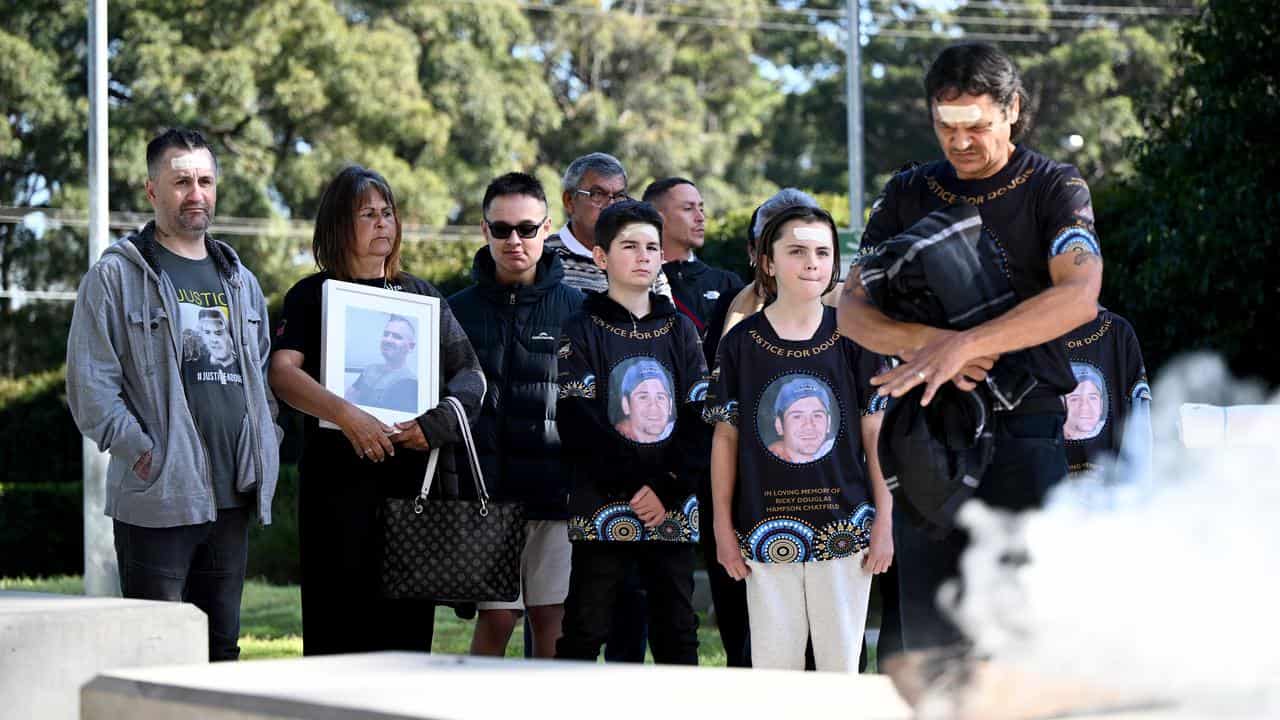 Family and friends of Rick Hampson during a smoking ceremony