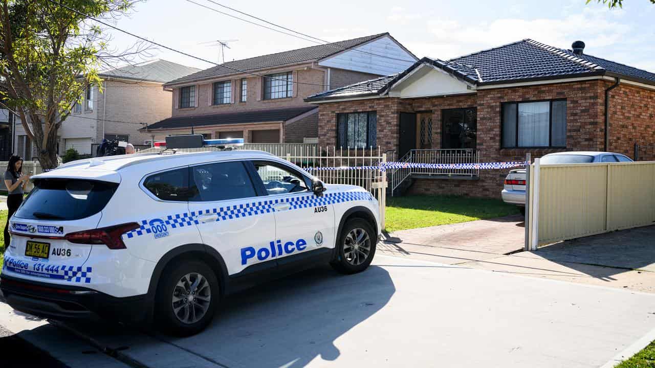 A police car in front of a house.