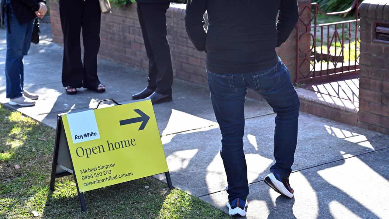 An open home sign in front of a house.