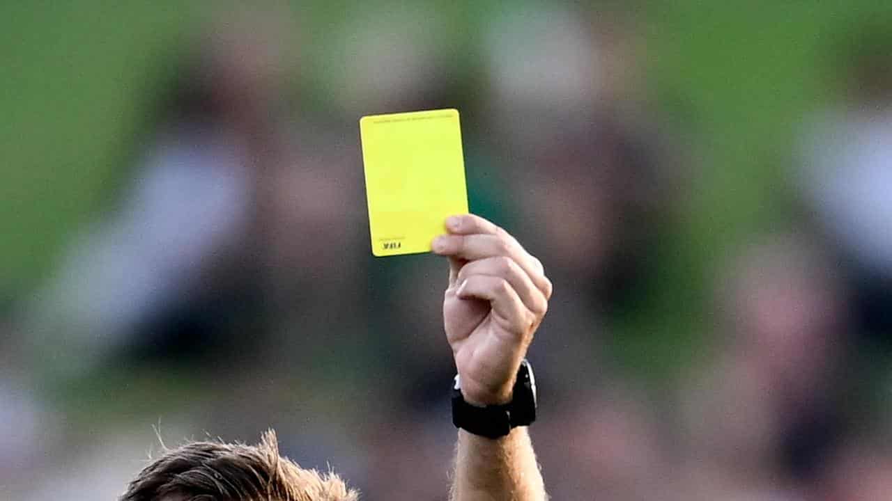 Referee holds up yellow card (file image)