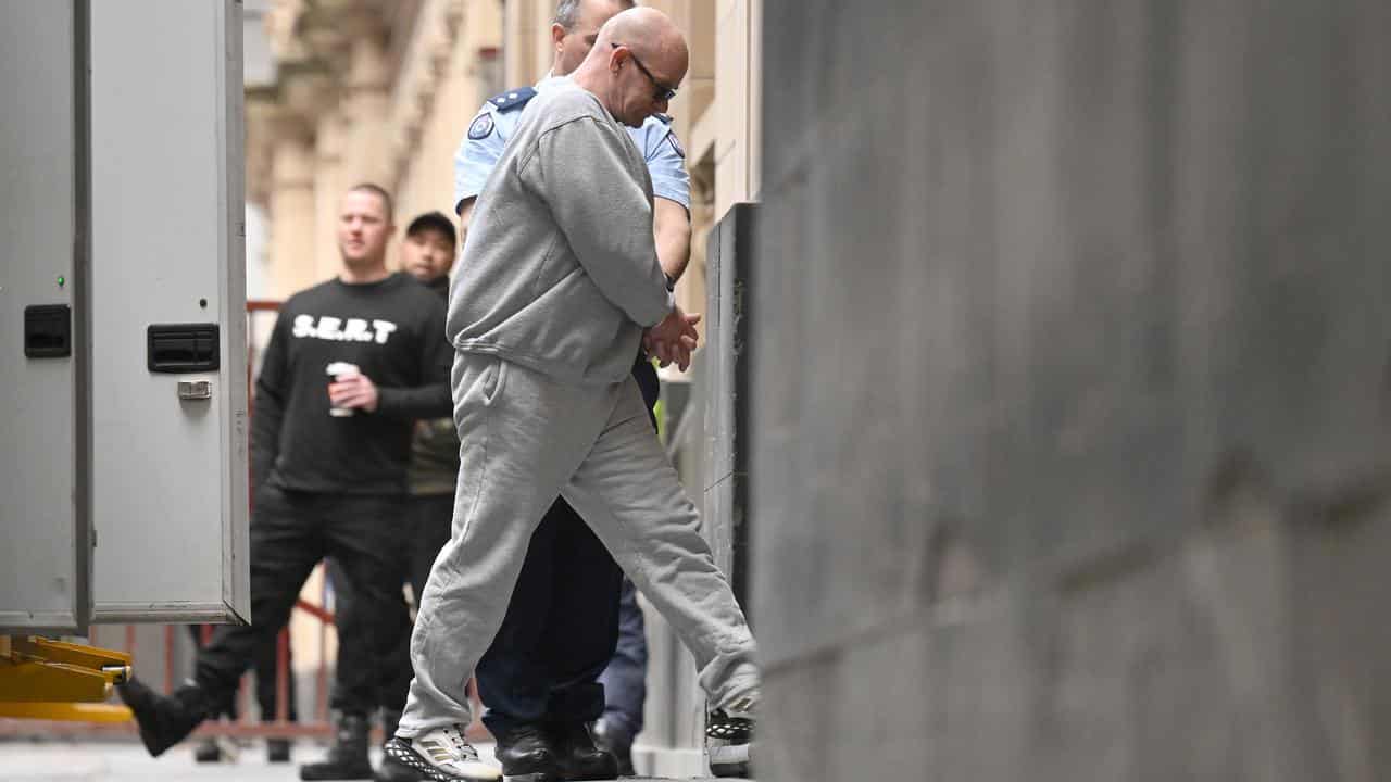 A man is led into court.