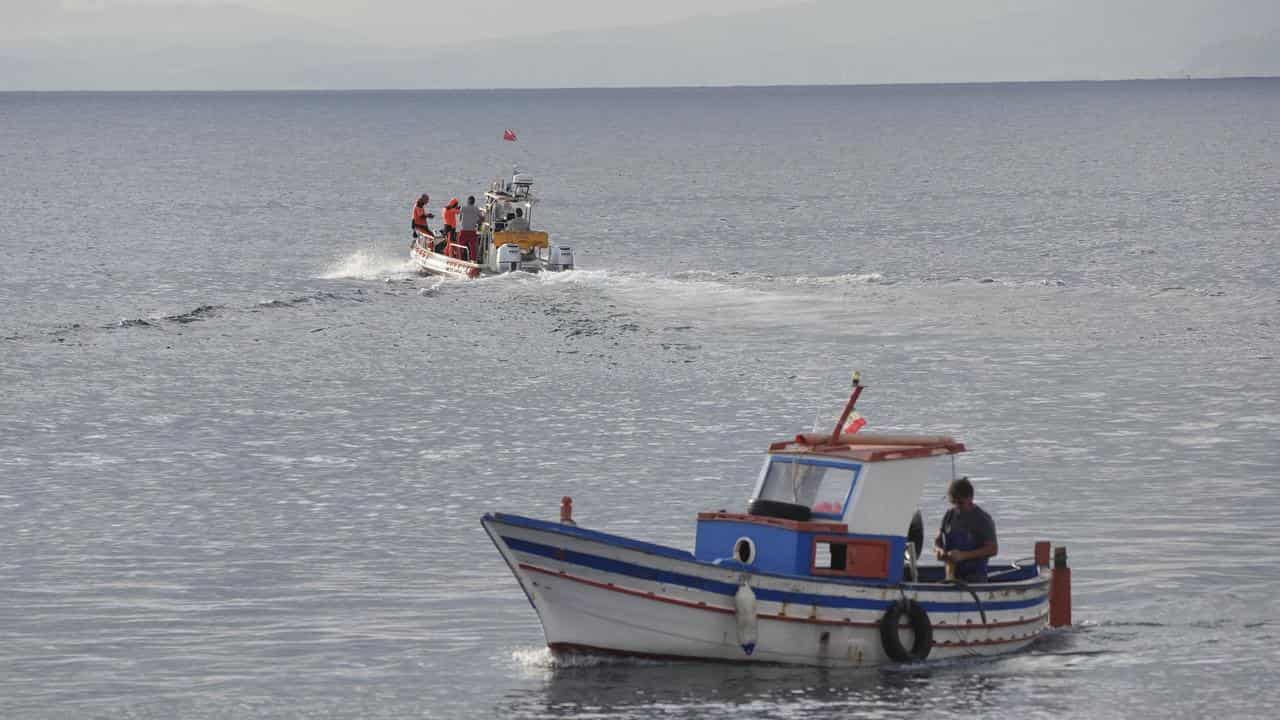 A boat heads out to the site of the Bayesian off Sicily