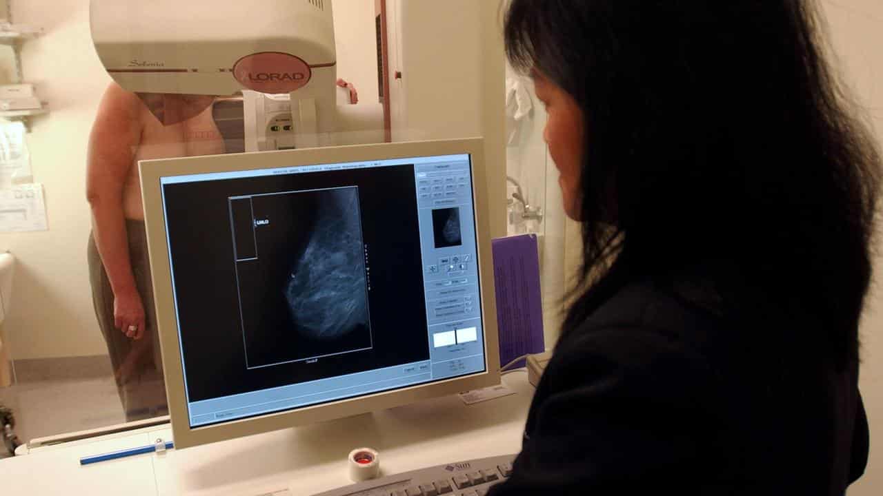 A radiographer performs a mammogram on patient (file image)