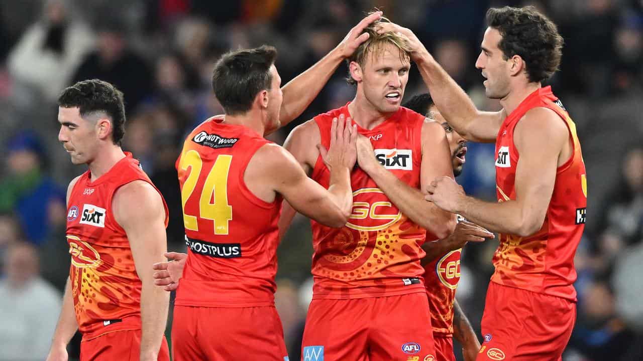 Gold Coast's Jack Lukosius (second right).