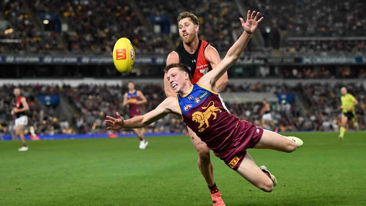 Dyson Heppell kept the pressure right on Brisbane's Logan Morris.