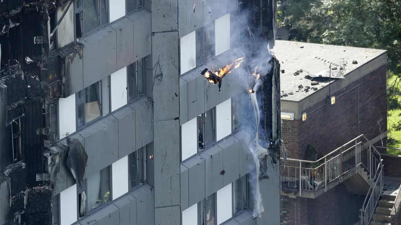 Burning debris falls from Grenfell Tower.