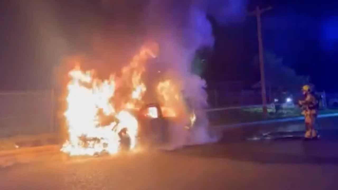 Firefighters attend a burning car in Granville