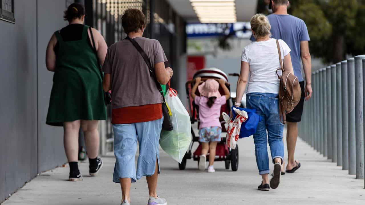 People carrying plastic shopping bags