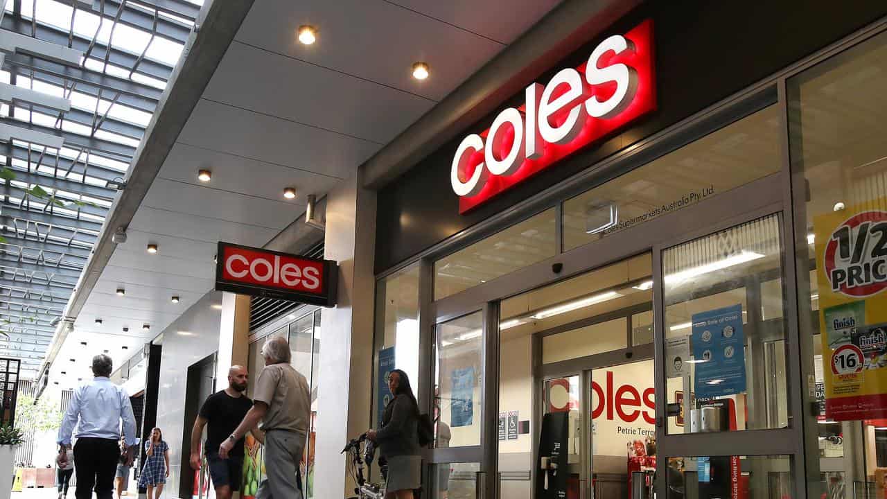 People outside a Coles store