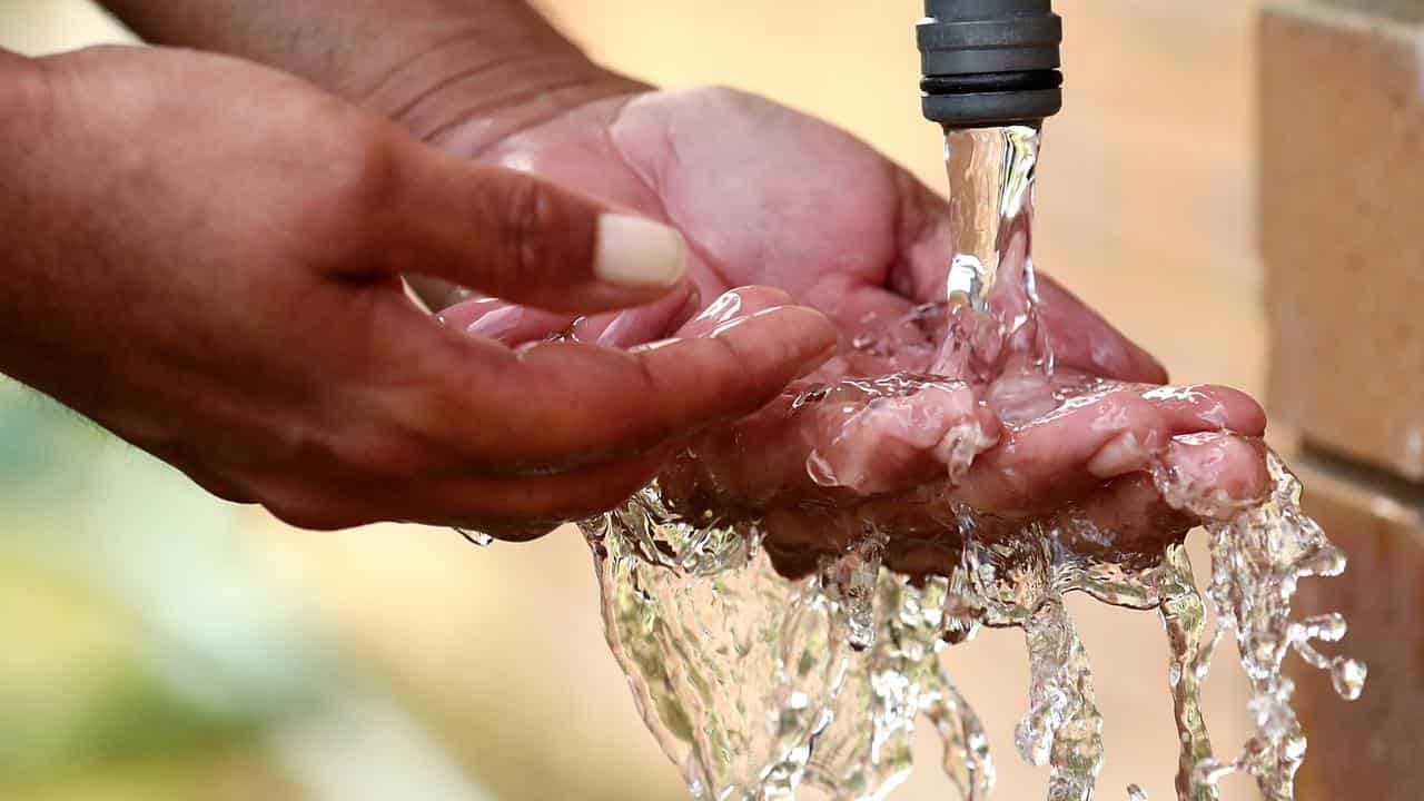 Water coming out of a tap.