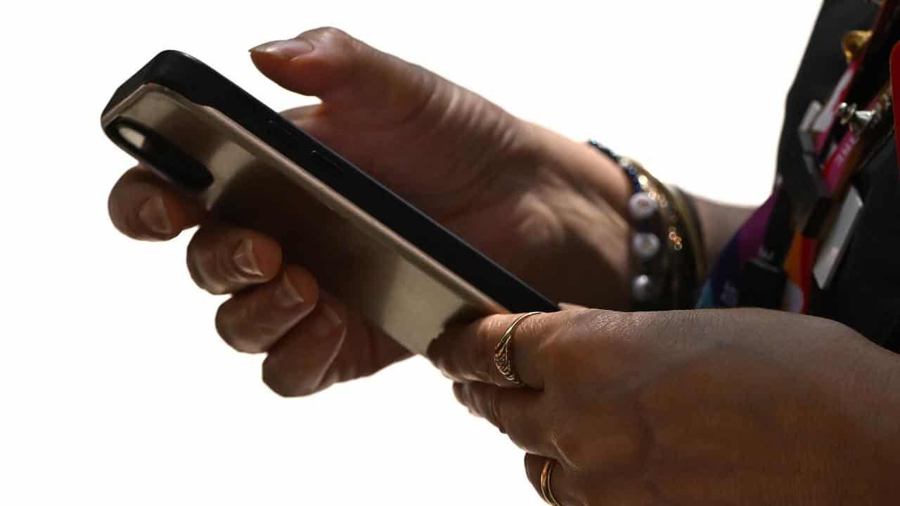 A woman seen using a smartphone device