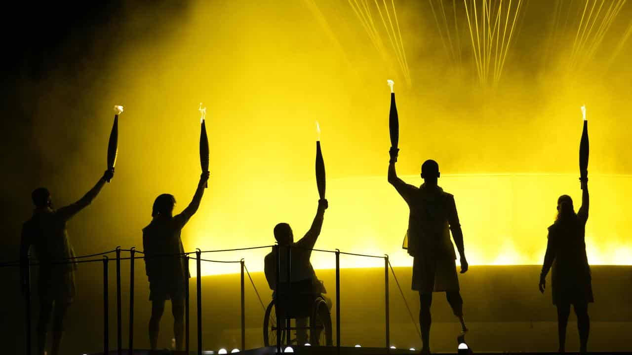 Athletes light the cauldron.