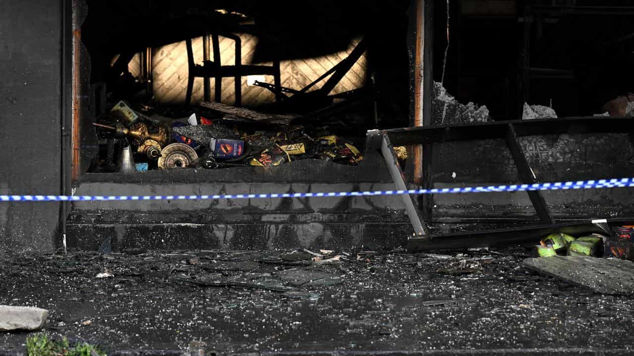 Burnt tobacco products are seen in a fire-damaged store.