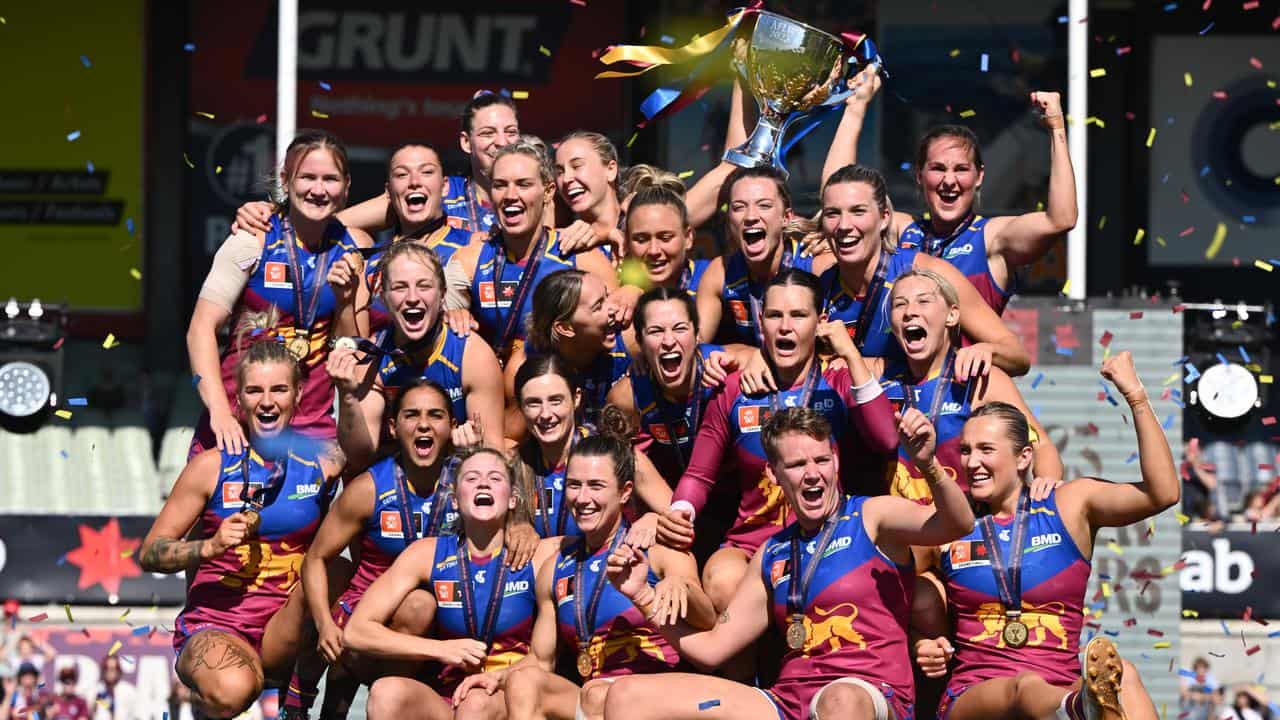 Brisbane Lions players celebrate winning the 2023 AFLW grand final.