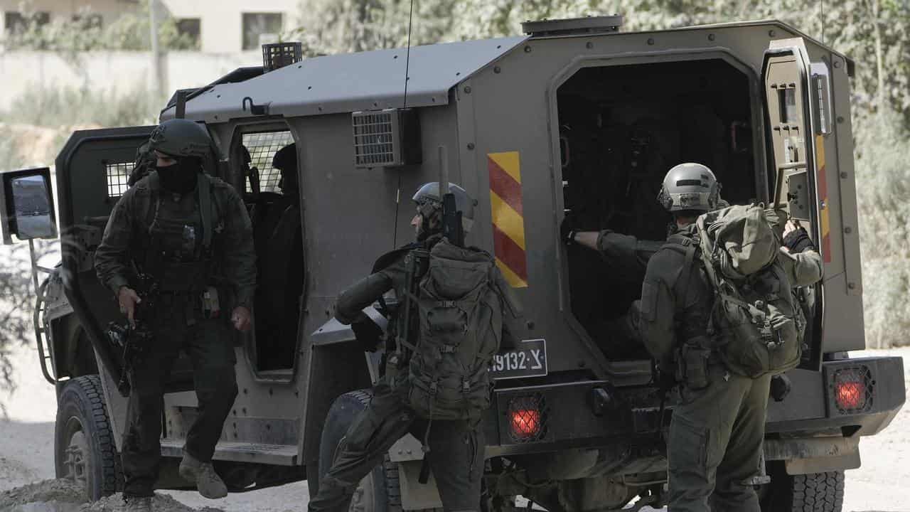 Israeli forces prepare to enter a West Bank refugee camp