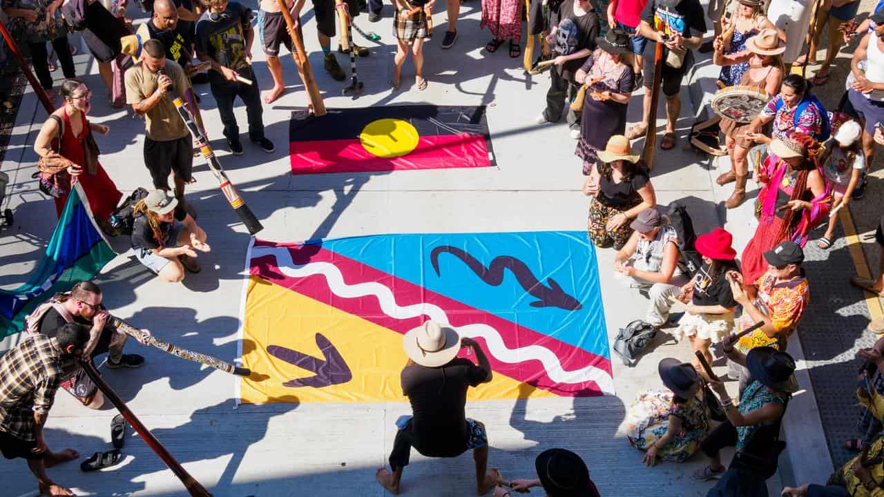 A flash mob of didgeridoos and clapsticks players in Brisbane