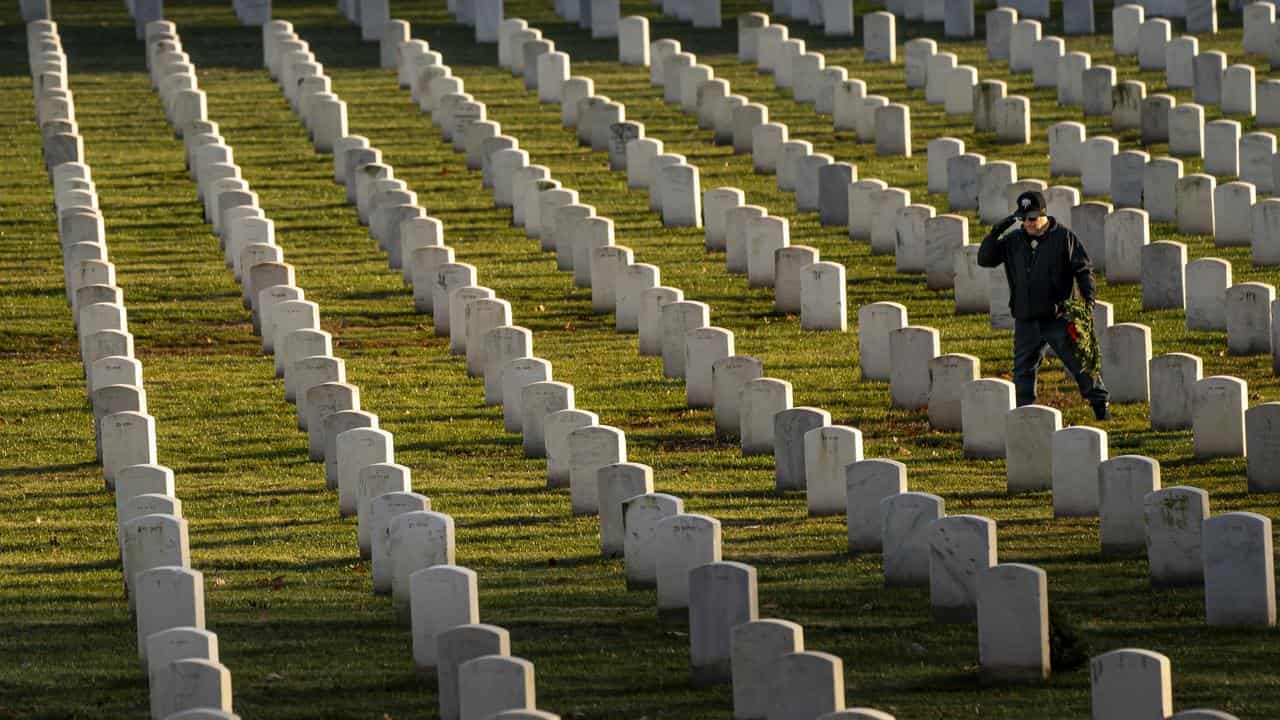 Shell Davis IV salutes grave at Arlington National Cemetery