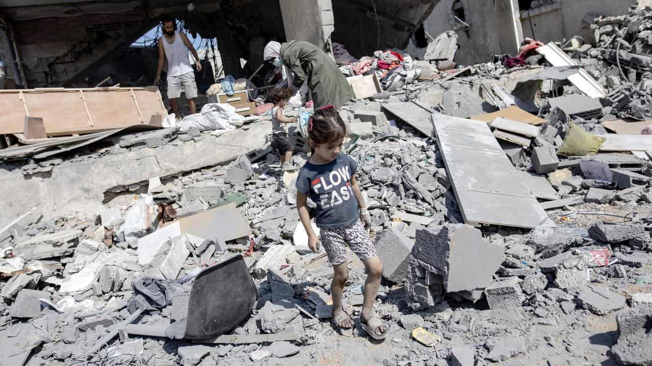 A child stands in the ruins of a building.