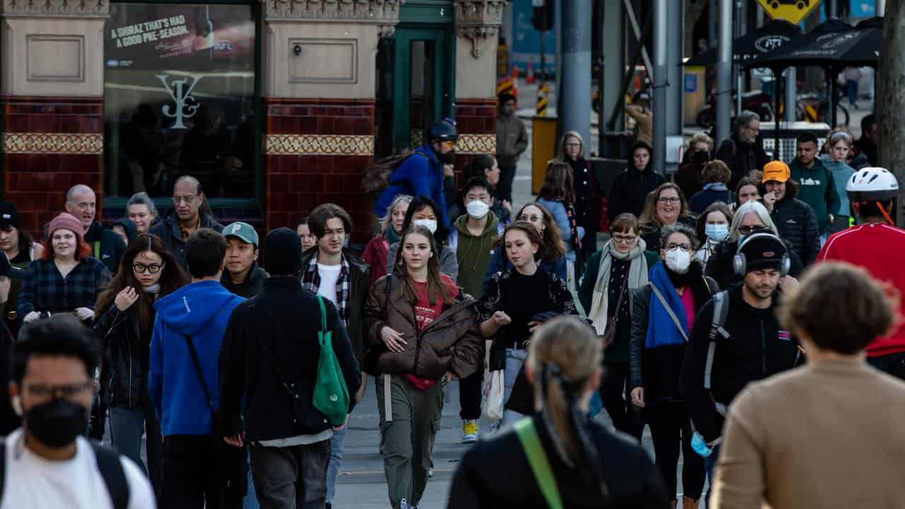 People walk along Flinders Street, Melbourne, 2022.