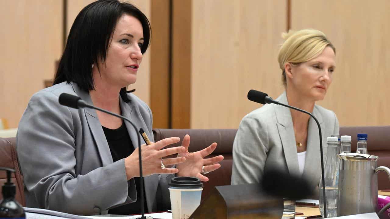 Two women at a parliamentary inquiry.