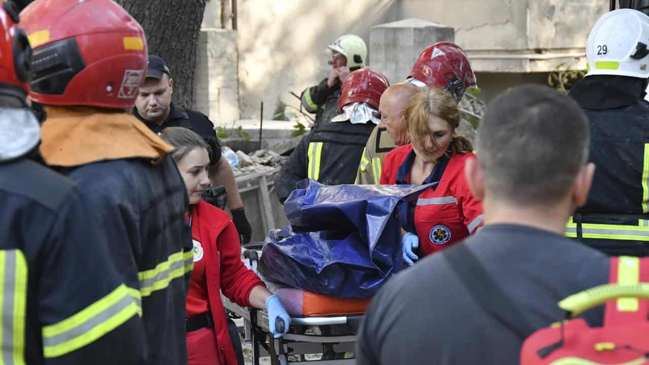 Rescuers carry a body after Russian missile attack in Lviv, Ukraine