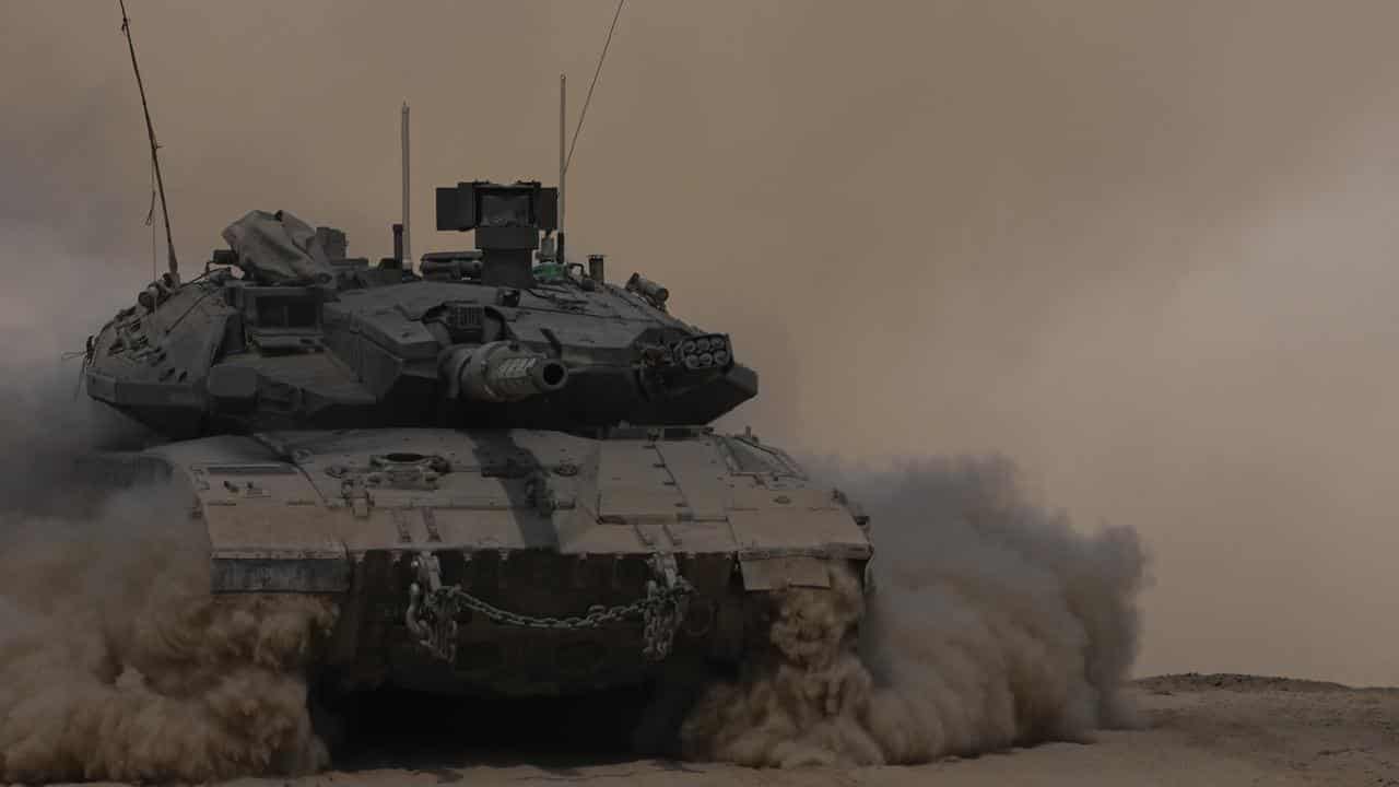 An Israeli tank manoeuvres near the Israel-Gaza border