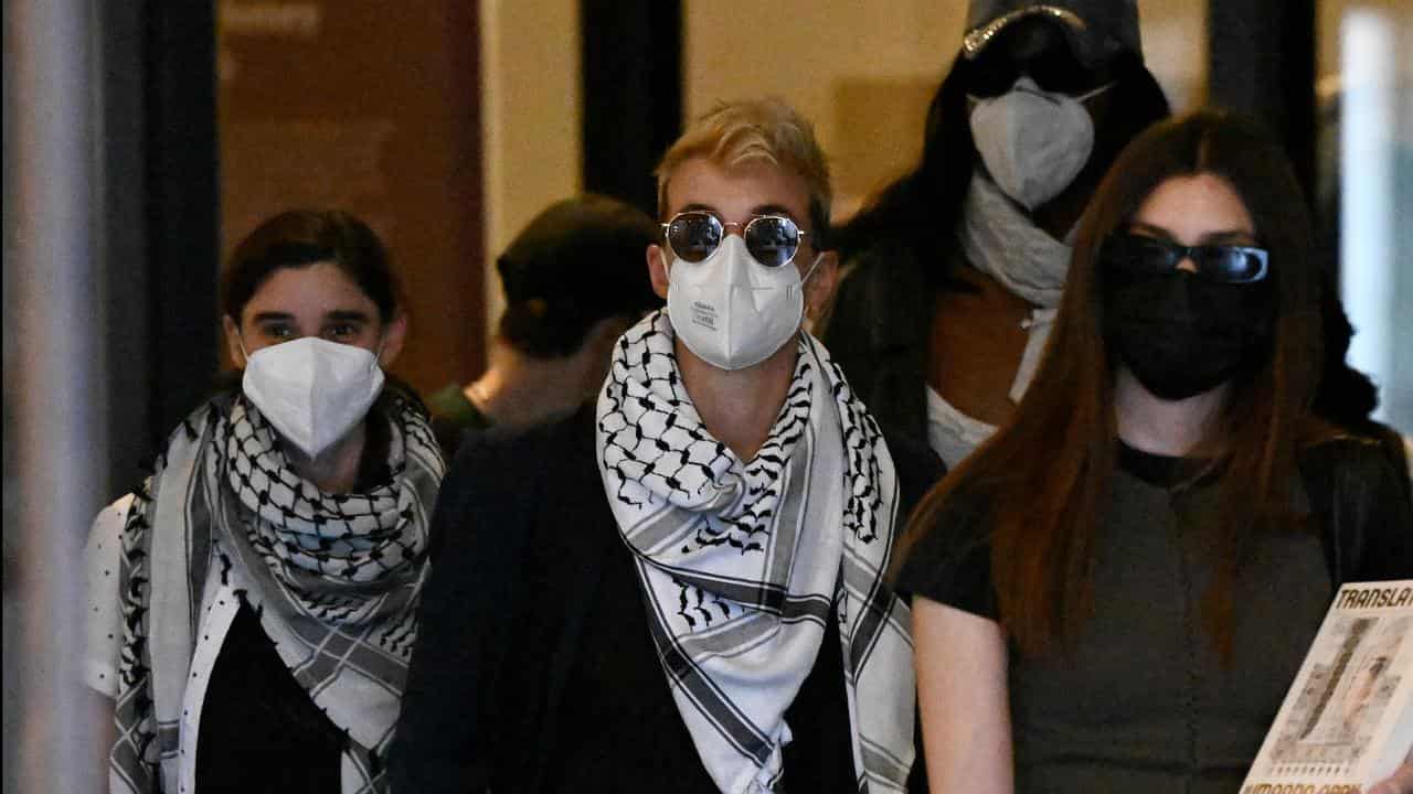 Alexandra Claire Moulis (centre) leaves court