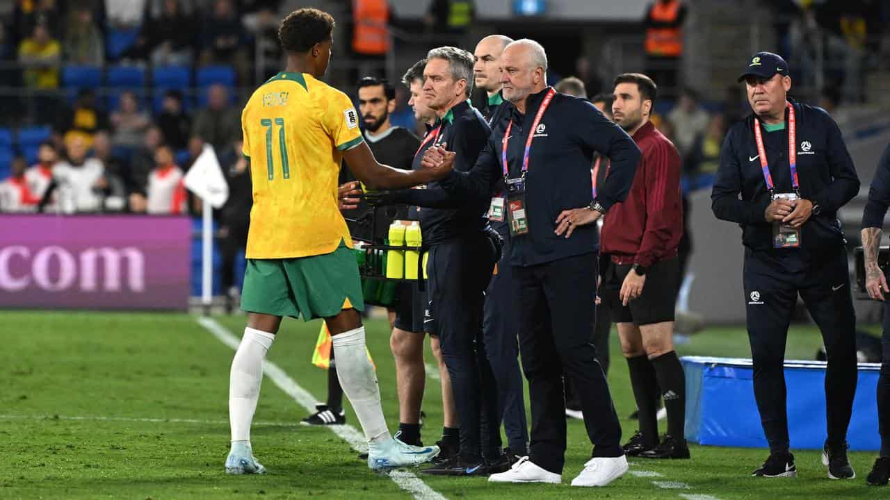 Kusini Yengi (left) checked in with coach Graham Arnold.