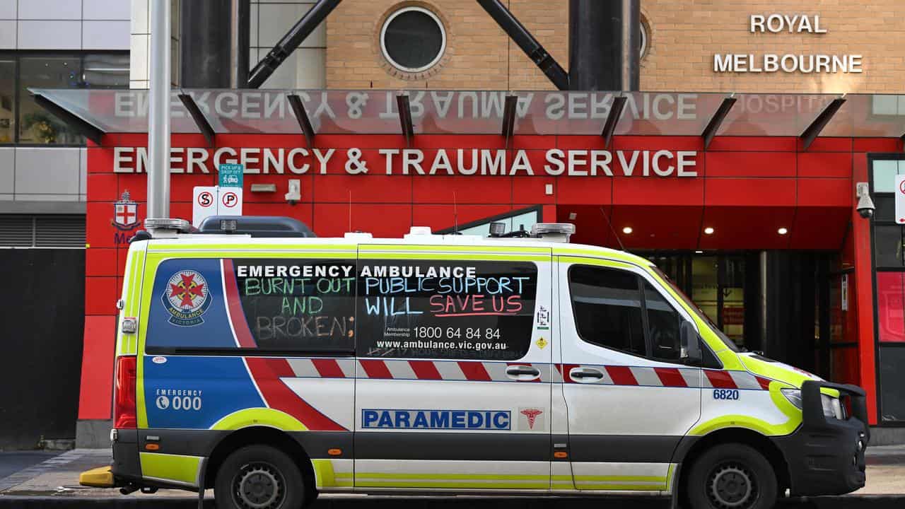 An ambulance in front of a hospital.