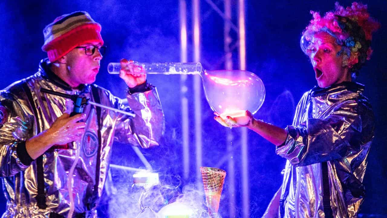 Performers Kurt Murray and Iulia Benze create bubbles