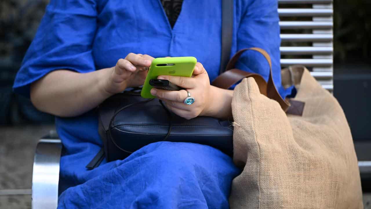 A woman uses a smartphone.