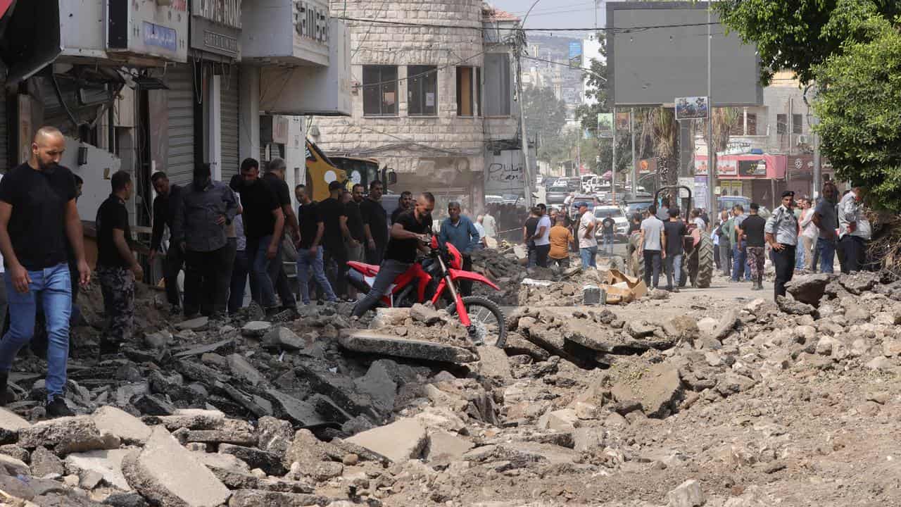 Palestinians inspect the damage