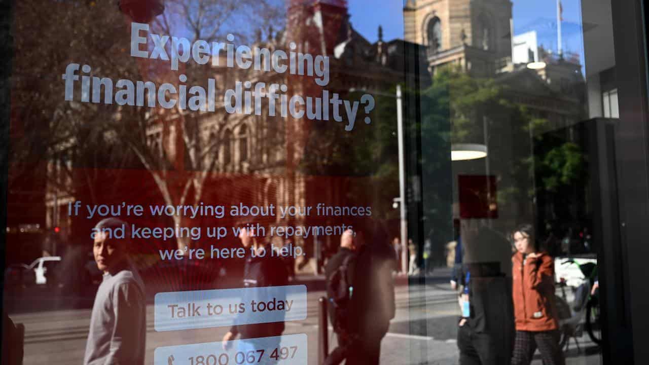 Financial help signage is seen in bank windows in Sydney