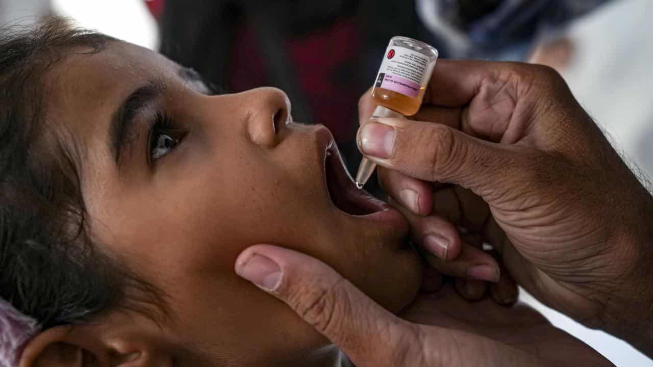 A health worker administers a polio vaccine in Deir al-Balah, Gaza