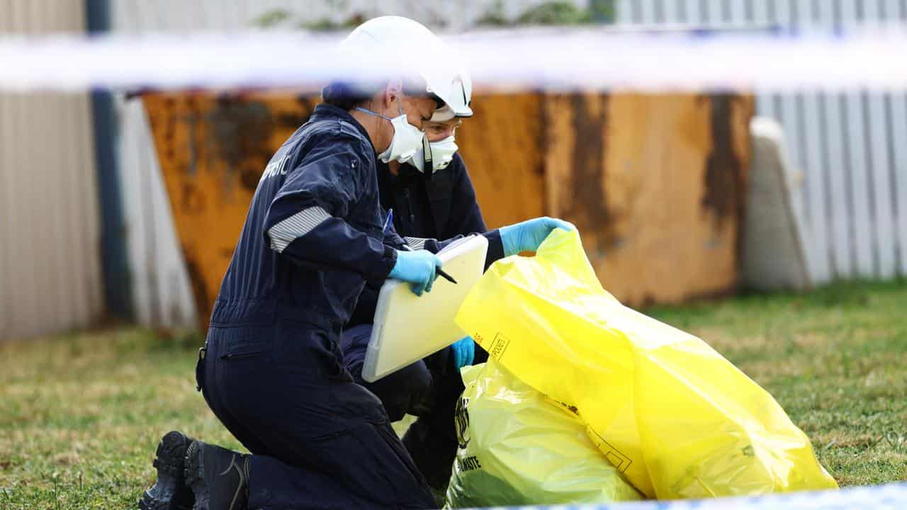 Forensic police at the scene of a house fire in Melbourne