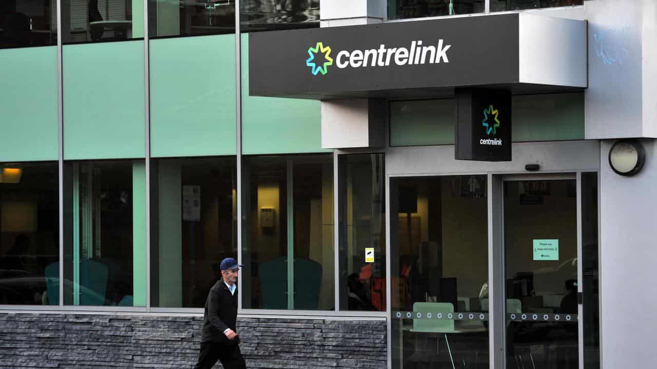 A man walks past a Centrelink branch in Melbourne